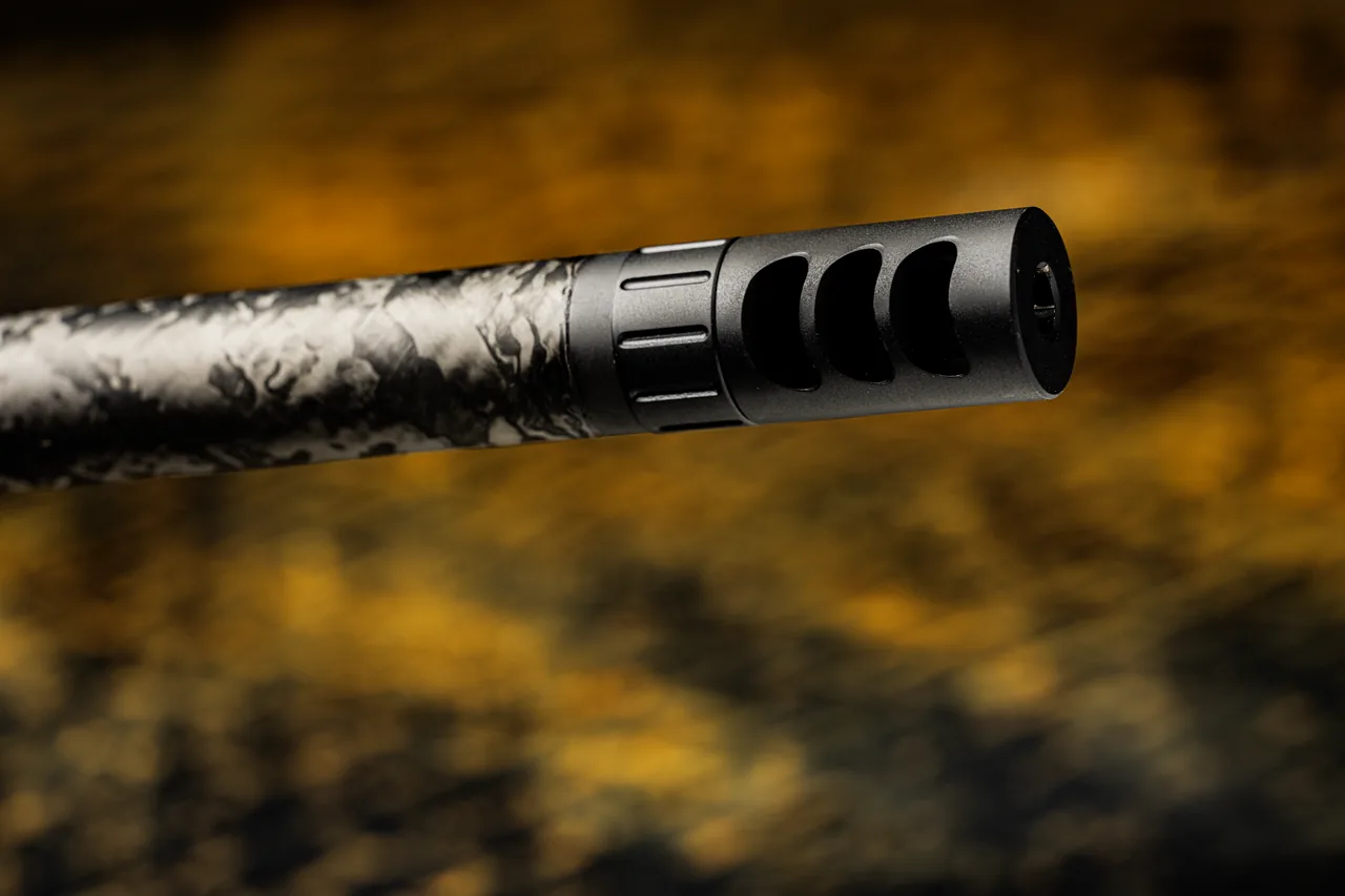 Watchtower Defense Stratis bolt-action rifle, close-up of the custom-machined muzzle brake and the hex opening at its muzzle end