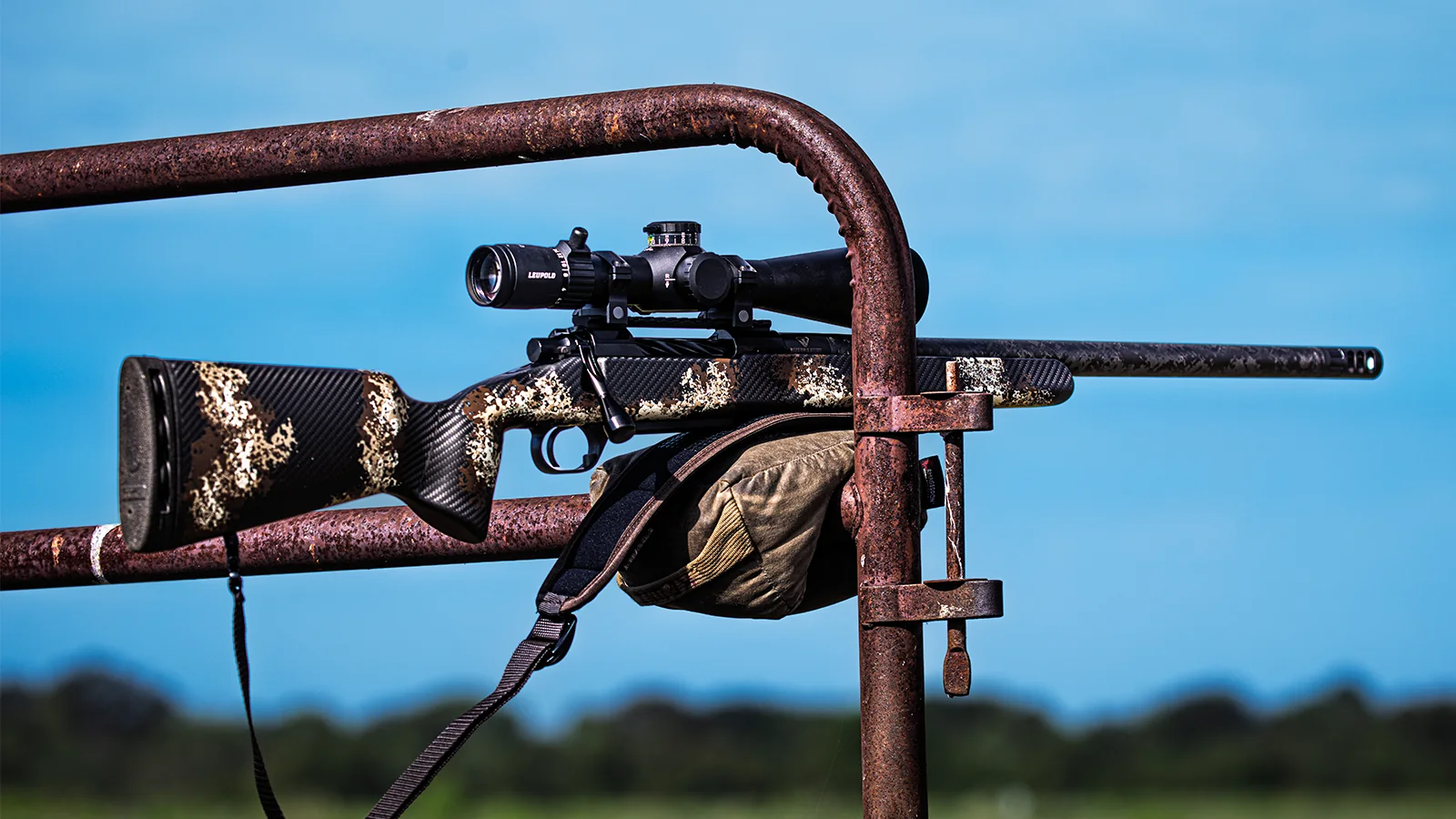 Watchtower Defense Stratis bolt-action rifle with a carbon fiber stock resting on a gate